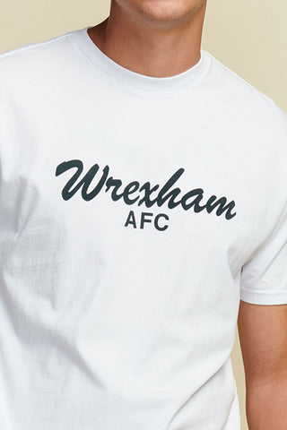 close up Photo of model wearing a white men's t-shirt with "wrexham afc" written in black script font. Short Sleeve