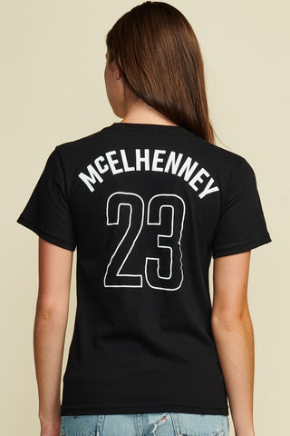 Photo of the back of the women's mcelhenney tee showing his last name and the number 23.Short Sleeve, white text.