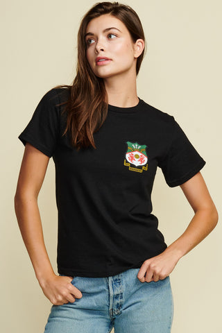 Photo of female model wearing black tee with wrexham crest on the left side of the tee. the back of the tee has the name McElhenney and the number 23. Short Sleeve 