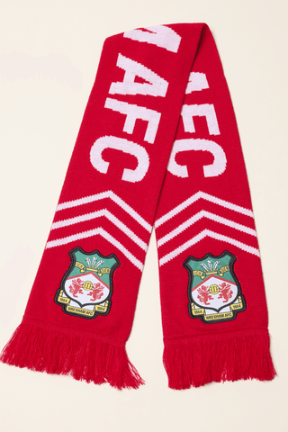 Photo of the wrexham scarf laid flat and showing the lettering that reads wrexham and the club badge