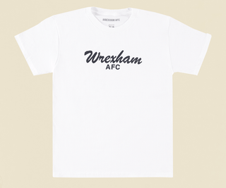 flat lay photo of a white youth tee with the words "wrexham afc" in black across the front