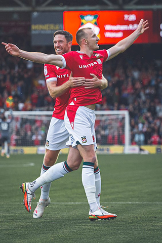 Photo of players celebrating after Wrexham Goal. 