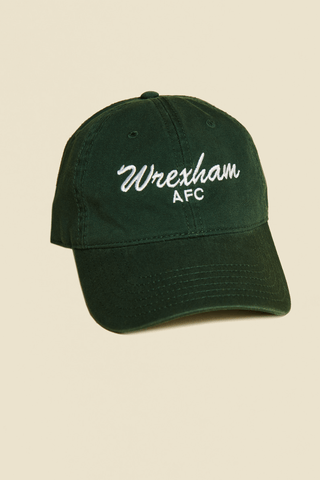 Product photo: green dad hat. Hat reads "Wrexham" in script font, text is white.
